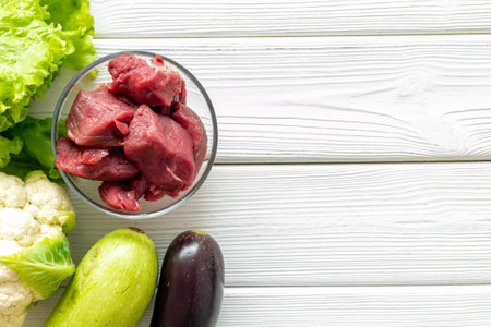 Keto diet food background. Raw beef meat and vegetables for cooking.の写真素材