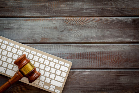 Wooden judge gavel and keyboard, top view. Lawyer desktop.