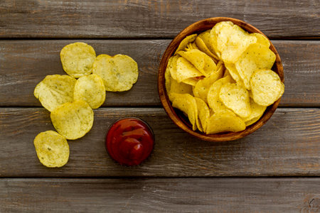 Oven backed low calorie potato chips. Snacks background, top view.
