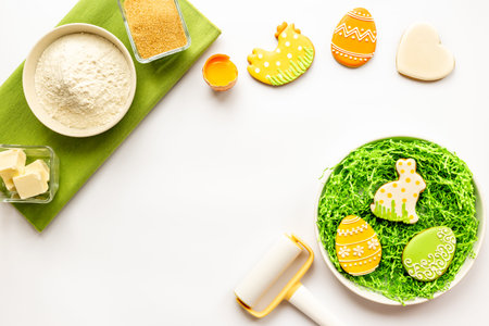 Easter eggs and bunny cookies with ingredients. Baking cooking flat lay.