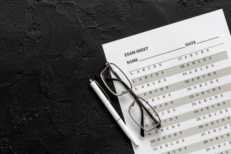 Answer exam sheet form on a table, top view. Education background.