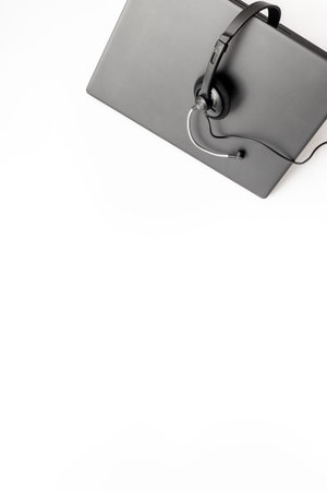 VOIP headset on laptop computer, top view. IT support, call center and customer service help desk...