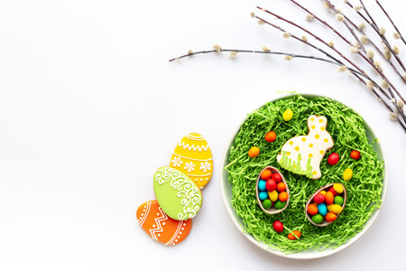 Happy Easter background with eggs and bunny cookies with spring branch, top view.の写真素材