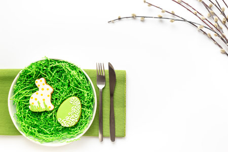 Easter table setting flat lay with egg and bunny cookies, top view.の写真素材