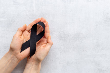 Black silk ribbon symbol of mourning and tragedy.の写真素材