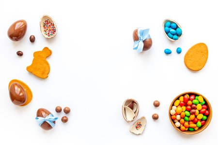 Easter festive background. Chocolate Easter eggs in blue ribbon with sweets.の写真素材