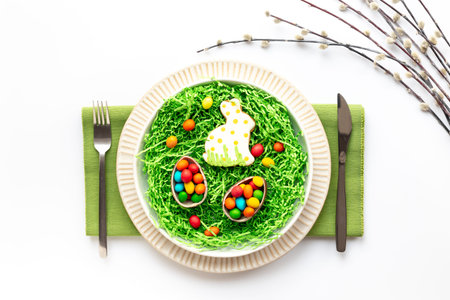 Easter table setting flat lay with egg and bunny cookies, top view.