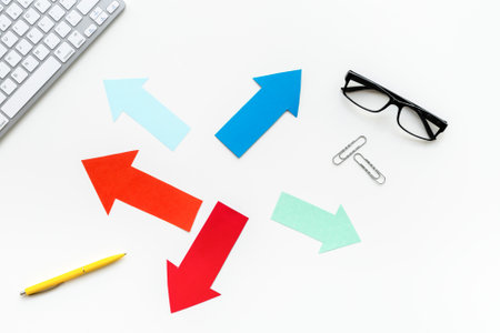 Paper arrows on office desk - problem solving options.の写真素材