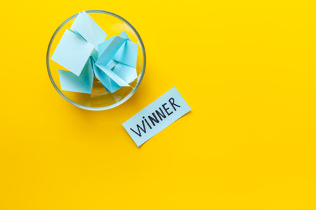 Lottery winner ticket near glass bowl full of paper sheets. Winner concept.の写真素材