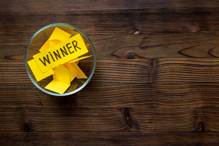 Winner concept. Lottery winner ticket in glass bowl full of paper sheets.の写真素材