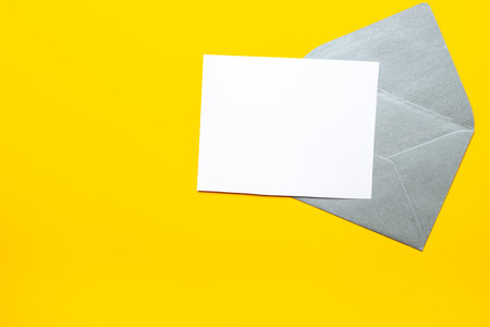 Blank sheet of paper on an envelope for letters. Space for text, top view.の写真素材
