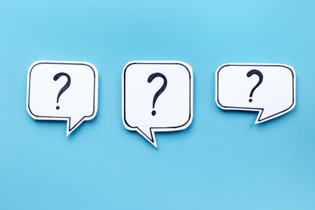FAQ concept - paper speech bubbles with question mark, top view.の写真素材