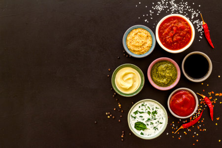 Many different sauces in bowls with spices and chili pepper. Food or cooking background.の写真素材