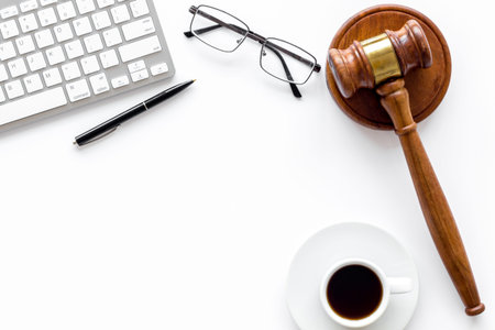 Lawyer desktop with Judge gavel and coffee cup.