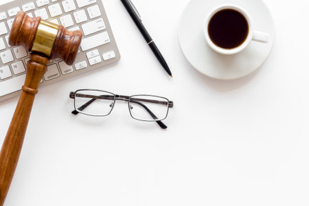 Lawyer desktop with Judge gavel and coffee cup.の写真素材