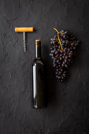 Bottle of red wine with bunch of grapes. Wine background.の写真素材