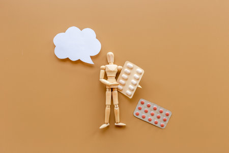 Wooden dummy man with medical pills. Medicine and healthcare concept.の写真素材