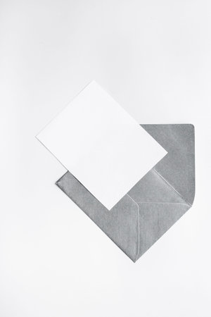 Blank sheet of paper on an envelope for letters. Space for text, top view.