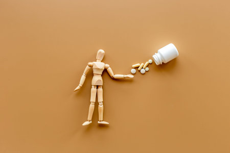 Wooden dummy man with medical pills. Medicine and healthcare concept.の写真素材