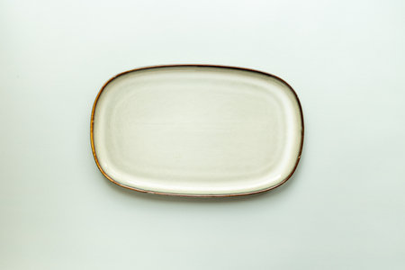Empty ceramic green plate on pastel background, top view.