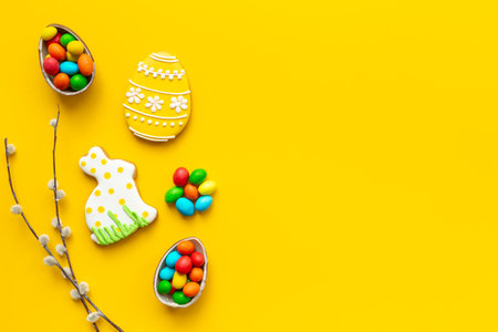 Easter eggs and bunny cookies with spring willow branch. Festive baking cooking flat lay.の写真素材