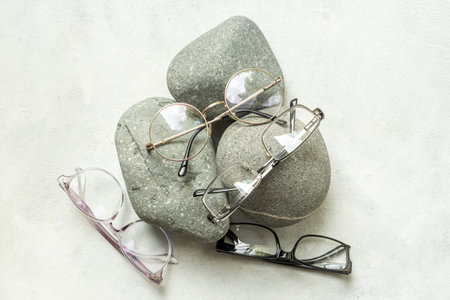 Flat lay of eyeglasses with different lenses, top view. Eyes healthcare concept.