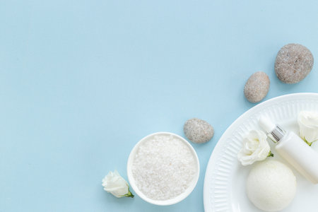 Frame of white cosmetics products and roses flowers, top view.の写真素材