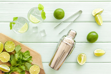 Alcoholic drink mojito making in blender with mint and lime, top view.の写真素材