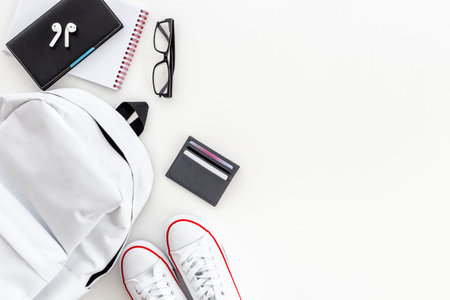 Flatlay of white backpack with wallet and bank cards and sneakersの写真素材
