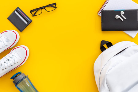 Top view of white backpack with men accessories, flatlay.