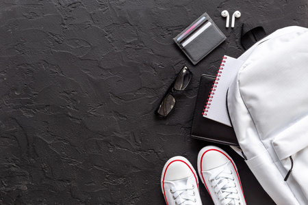 Top view of white backpack with men accessories, flatlay.