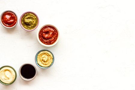 Set of sauces in bowls - pesto salsa mustard and others. Food background.