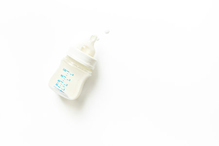 Bottle of milk for baby feeding on white background, top viewの写真素材