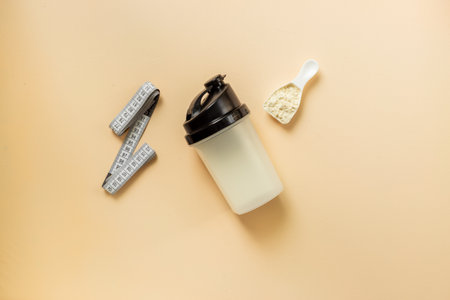 Protein shaker for sports nutrition. Whey protein powder in a scoop, top view.の写真素材