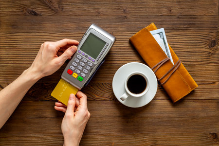 Paying a bill for a coffee at a cafe - bank payment terminal for payment by credit cards.の写真素材