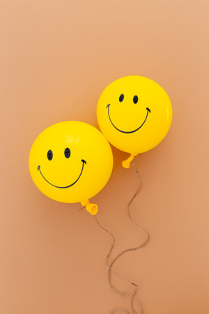 Yellow balloon with smiling face against the wall.の写真素材