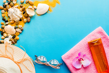 Sunbathe accessories with sea sand and shells, top view. Beach flat lay