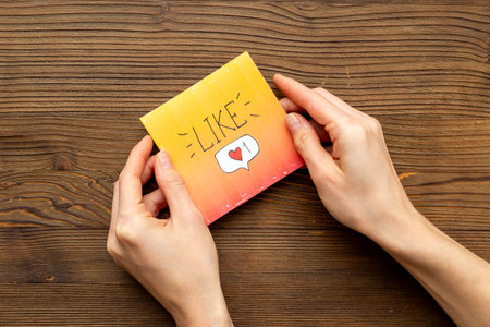 Hands holding Like icon for social media. Digital marketing concept.