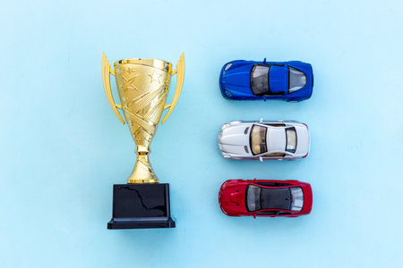 Champion golden trophy cup with car model. First place winning the competition concept.の写真素材
