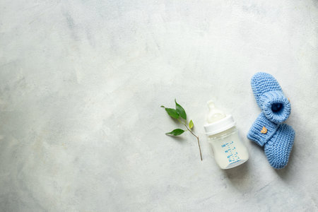 Kids flat lay with baby shoes and milk in bottle, top view.の写真素材