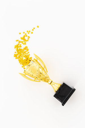 Award victory trophy cup with golden stars, top view. Success and victory concept.