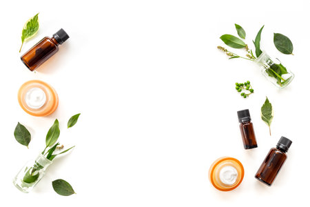 Herbal treatment with extract or essential oil and green fresh healing herbs, top viewの写真素材