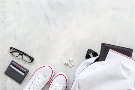 Flatlay of white backpack with wallet and bank cards and sneakersの写真素材