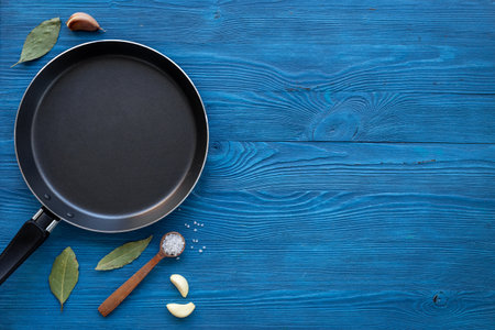 Black empty frying pan and spices. Cooking layout. Menu concept.の写真素材