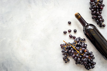 Wine concept with bottle of red wine and bunch of grapes.の写真素材
