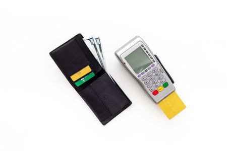 Choosing payment method concept. Bank payment terminal with credit cards and wallet, top view.
