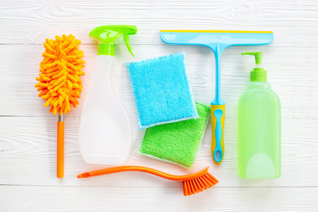 Cleaning service concept with chemical cleaning supplies bottles and tools.