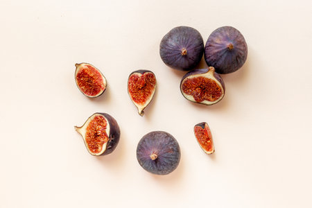 Whole and cut fresh ripe figs on stone table. Top view.の写真素材