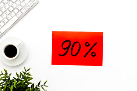 Sales concept. Online shopping - white table with computer and discount sing, top view.