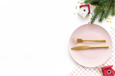 Festive table setting for Christmas and New Year Eve - plate with fir tree branch and decoration on white table, top view.の写真素材